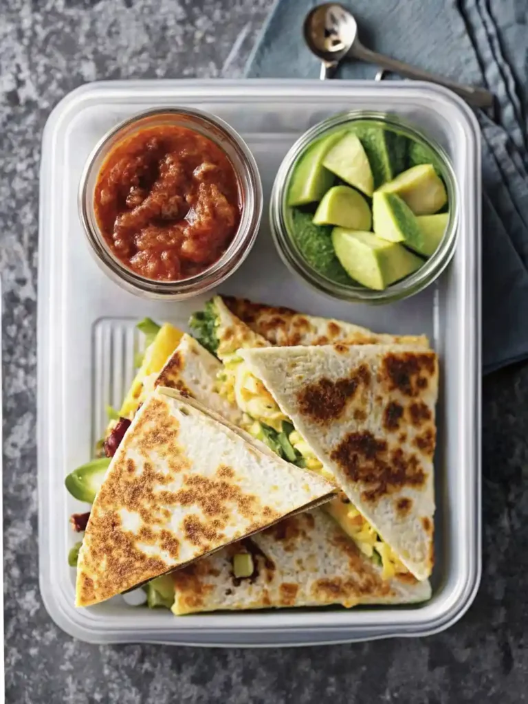 healthy chicken quesadilla meal prep, salsa in a jar, and avocado chunks in a glass cup