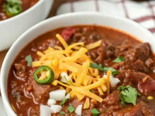 Bowl of authentic Texas chili recipe with beef, spices, and no beans.