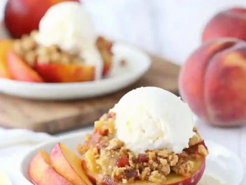 Baked stuffed peaches with streusel and topped with a scoop of ice cream.