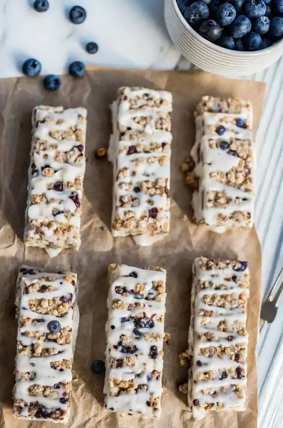 Homemade blueberry vanilla granola bars with a creamy Greek yogurt layer – recipe by CookJoy Recipes.