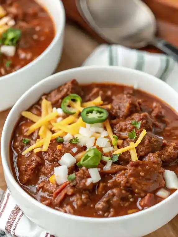 Bowl of authentic Texas chili recipe with beef, spices, and no beans.