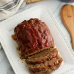 Delicious lipton's onion soup meatloaf recipe​ served with a side of vegetables.