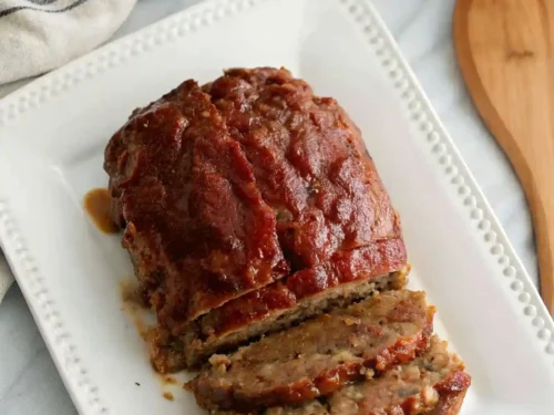 Delicious lipton's onion soup meatloaf recipe​ served with a side of vegetables.