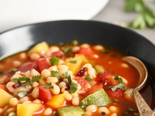 Bowl of Three Sisters Soup Recipe made with corn, squash, and beans.