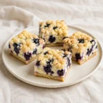 Blueberry cream cheese bars with shortbread bases and golden crumble topping.